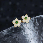 White Jade Flower Earrings placed on natural stone background showing elegant craftsmanship | TheFuMaster