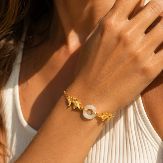 White jade koi bracelet worn on the wrist