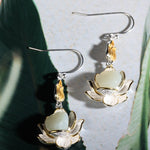 Elegant White Jade Lotus Drop Earrings displayed under natural light emphasizing smooth jade luster