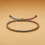Colorful braided bracelet on a beige background