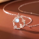 Close-up of TheFuMaster Moon Flower Moonstone Necklace in rose gold with rabbit motif and glowing moonstone pendant